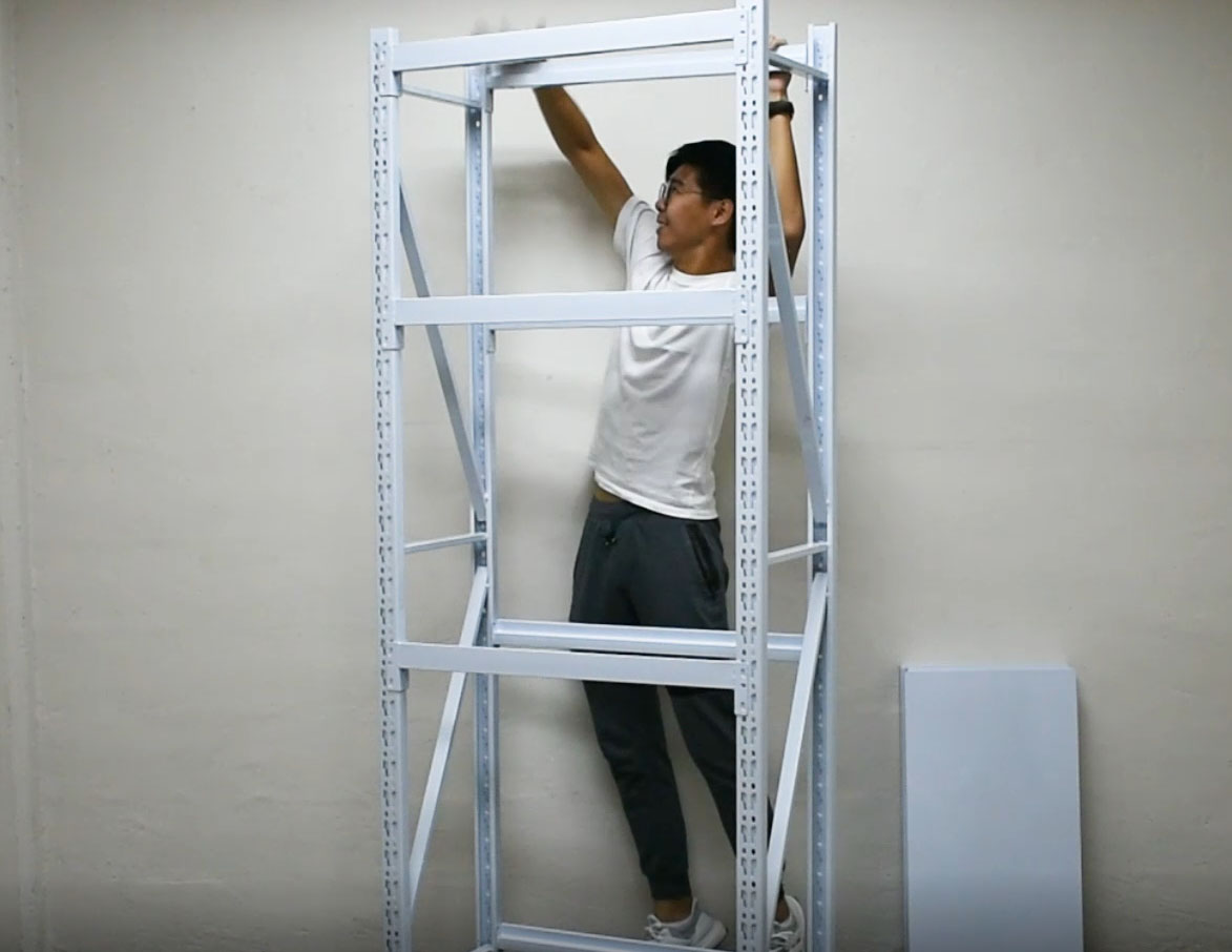 A standing boltless rack frame with horizontal side frames fitted at bottom, middle and top levels, the diagonal bracing of both side frames clearly visible, with the top beam being fitted